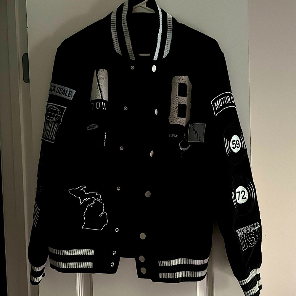 Black Varsity-Style Jacket Featuring Black and White Accents